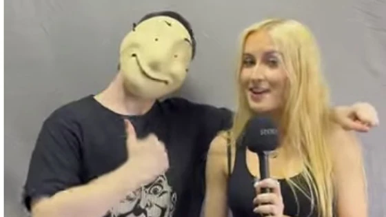 Two Acting & Performance students at Glasgow Kelvin College pose during an interview—one wears a mask and gives a thumbs up, while the other holds a microphone and smiles. Two Acting & Performance students at Glasgow Kelvin College pose during an interview—one wears a mask and gives a thumbs up, while the other holds a microphone and smiles.